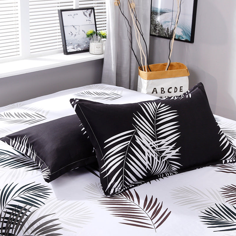 Close-up of the VibeCore Aesthetic Black Leaf Pillowcase, featuring a bold black and green leaf pattern. Made from a soft cotton-polyester blend, this pillowcase adds nature-inspired elegance and comfort, perfectly complementing the duvet cover set.