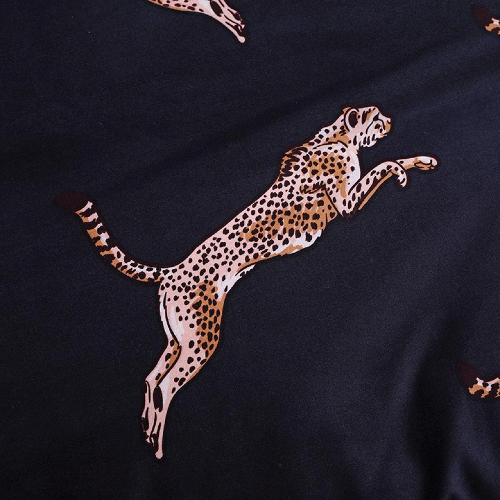 Close-up of the bold cheetah cat print on the VibeCore Aesthetic duvet cover set, showcasing a jumping cheetah cat that adds a fun, trendy touch to your bedroom decor.