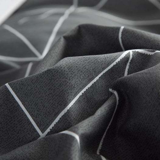 Close-up of the soft cotton-polyester blend material of the VibeCore Aesthetic Gray Geometric Duvet Cover Set, showcasing its smooth texture and durability. The modern geometric pattern in gray tones adds both style and comfort, making it perfect for contemporary bedrooms or dorms.