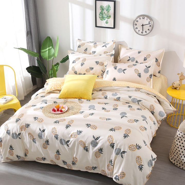 Aerial angled view of the VibeCore Aesthetic Pineapple Duvet Cover Set, highlighting the vibrant tropical pineapple pattern. The soft cotton-polyester blend offers a cozy, year-round feel, bringing a fun and energetic vibe to any bedroom or dorm space.