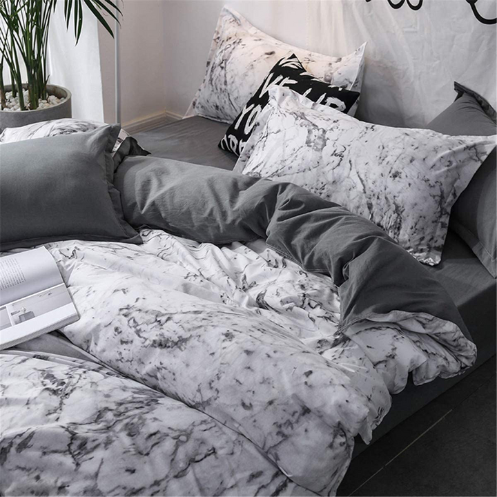 Close-up right aerial view of VibeCore Aesthetic White Marble Duvet Cover Set, highlighting the sleek white marble design and soft cotton-polyester blend fabric. The elegant pattern adds sophistication to modern bedrooms or dorm rooms, offering comfort and durability for year-round use.