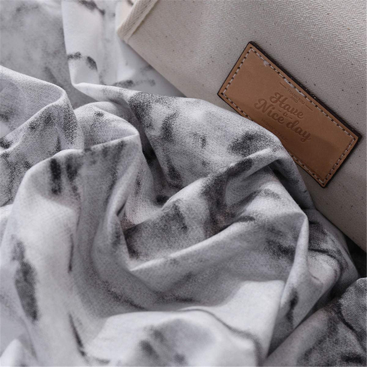 Close-up of the soft cotton-polyester blend material of the VibeCore Aesthetic White Marble Duvet Cover Set, showcasing its smooth texture and durability. The fabric combines comfort and elegance, making it perfect for modern bedrooms and dorm rooms.
