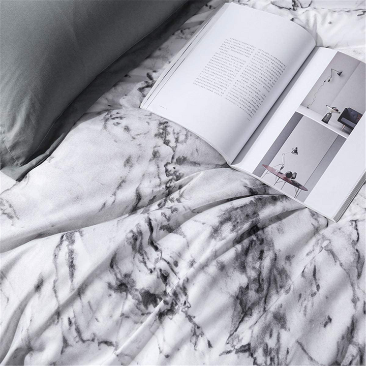 Close-up of the sleek white marble pattern on the VibeCore Aesthetic White Marble Duvet Cover Set, showcasing its elegant design and soft cotton-polyester blend fabric. Perfect for modern bedrooms and dorms, this bedding set combines style and comfort.
