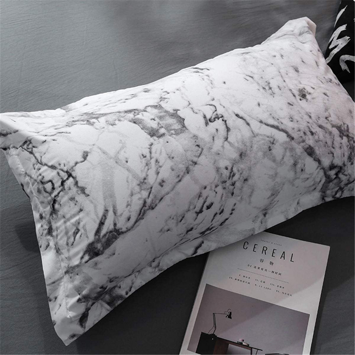 Close-up of the VibeCore Aesthetic White Marble Pillowcase featuring the elegant white marble design, made from a soft cotton-polyester blend for added comfort. Complements the sleek and modern style of the duvet cover set, perfect for bedrooms and dorm rooms.