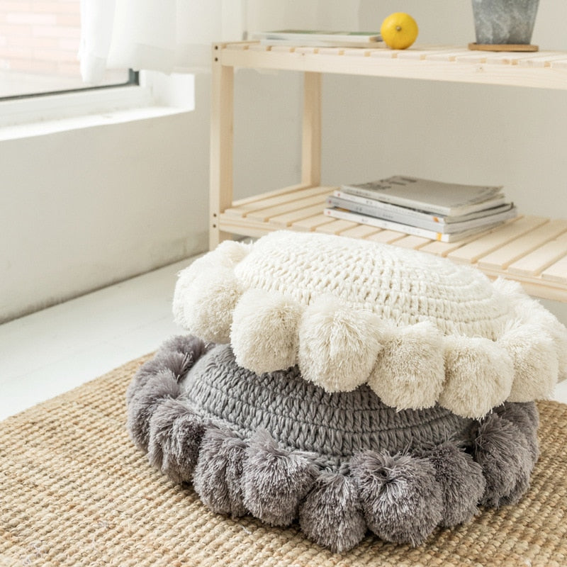 VibeCore Hand-Knitted Pompom Cushions in white and gray stacked together, showcasing their elegant boho design and soft, plush texture.