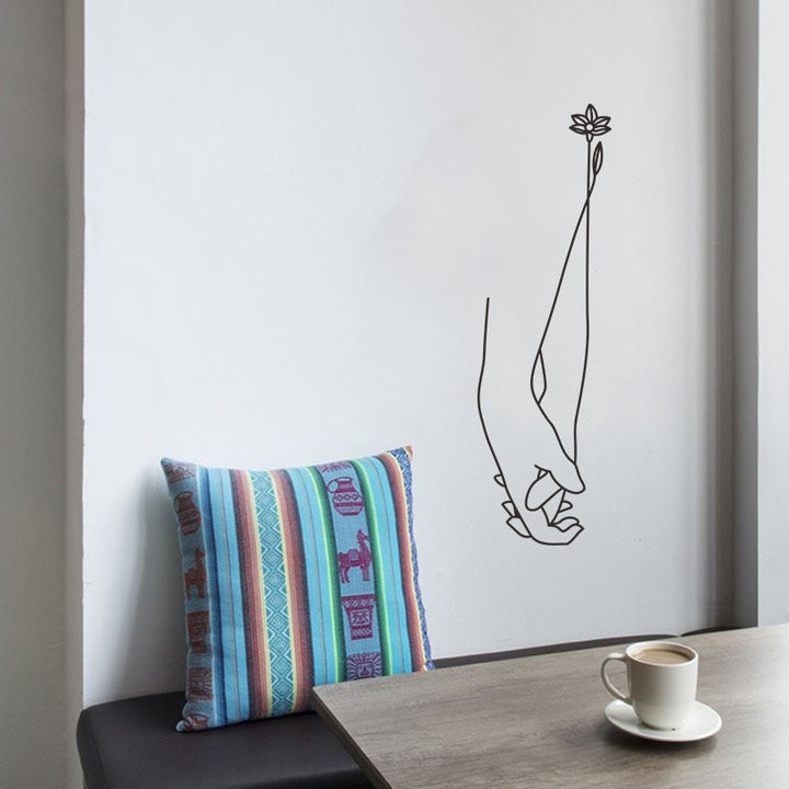 Interlaced hands wall sticker on a wall in the dining room, adding a unique, artistic touch that enhances the space with elegance and positive energy.