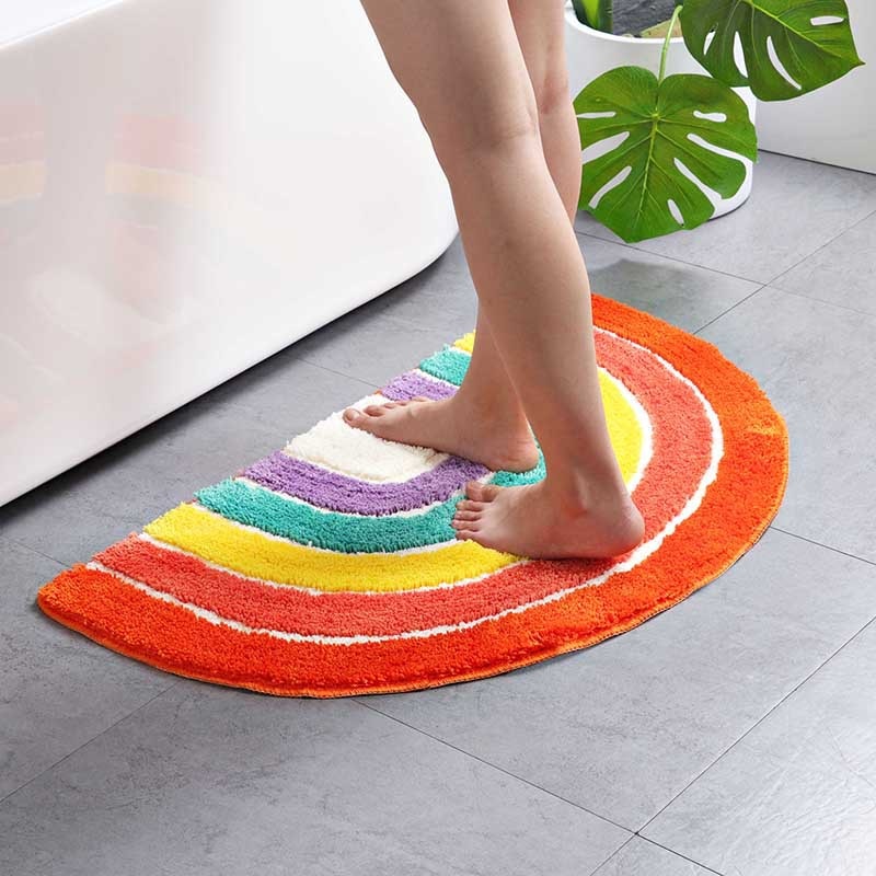 VibeCore Rainbow Plush Rug by the bathtub, showcasing vibrant colors and a soft, fluffy texture. Water-absorbent with a non-slip backing, ideal for adding comfort and style to your bathroom or any space. Durable and easy to clean, this rug is a perfect modern accent.