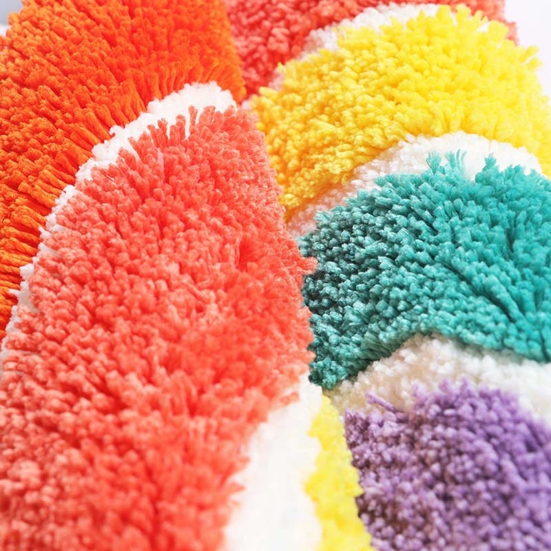VibeCore Rainbow Plush Rug made from durable polyester fiber, offering a soft, fluffy texture. Water-absorbent and designed with a non-slip backing for added safety and comfort. Easy to clean and maintain, perfect for any space.
