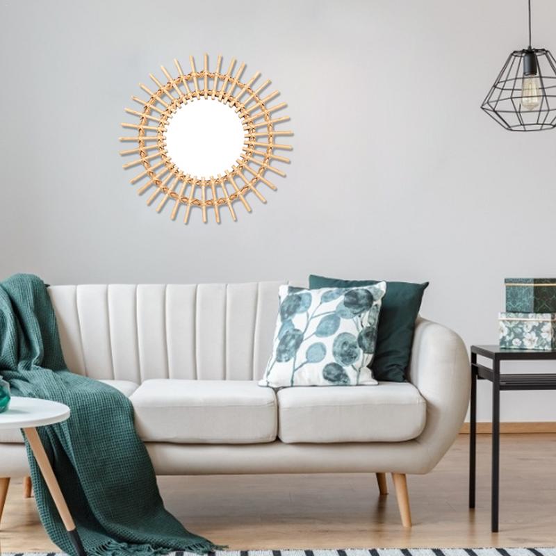 VibeCore Rattan Sun Mirror made from natural rattan with a reflective center, showcasing a boho-inspired design for wall decor.