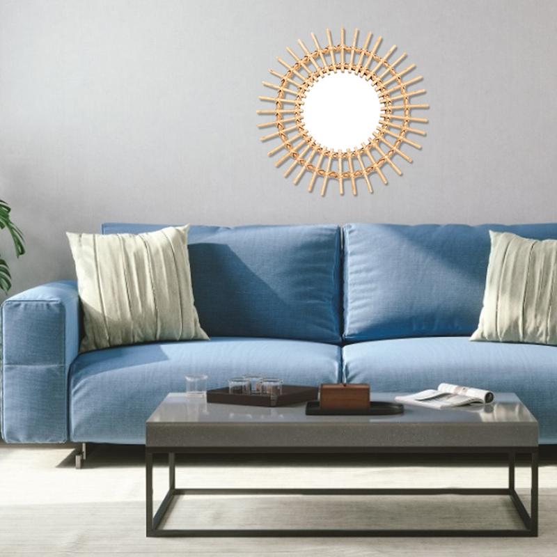 VibeCore Rattan Sun Mirror displayed on a living room wall, enhancing the space with its natural rattan frame and reflective glass, adding a boho, tranquil vibe to the room.