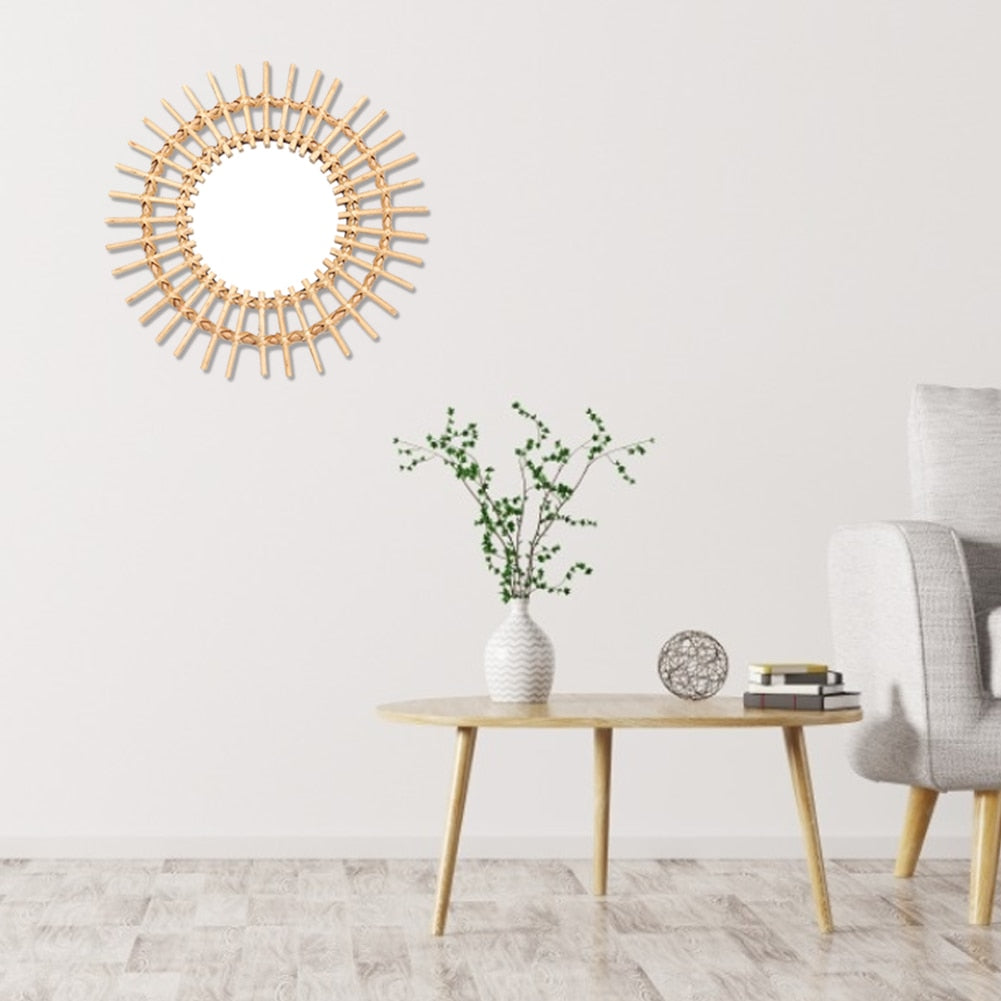 VibeCore Rattan Sun Mirror hanging on a wall, showcasing its natural rattan frame and clear reflective glass, adding a boho-chic vibe to the room.